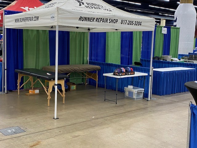 Runner Repair Shop event booth with treatment table